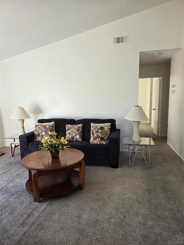 carpeted living room featuring lofted ceiling