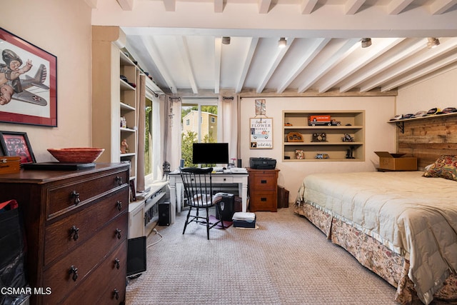 carpeted bedroom with beam ceiling