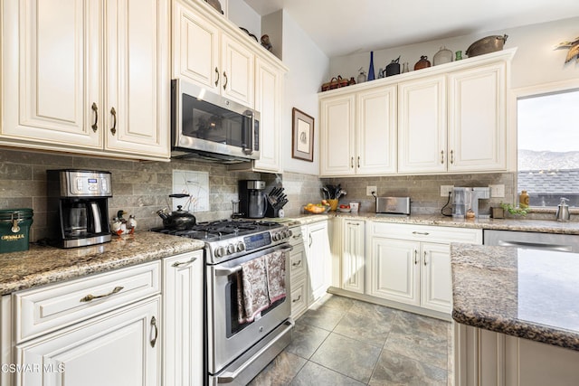 kitchen featuring stone counters, decorative backsplash, and appliances with stainless steel finishes