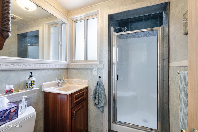 bathroom featuring toilet, walk in shower, and vanity