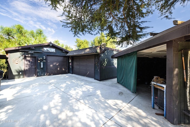 view of home's exterior with an outdoor structure and a garage