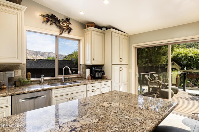 kitchen featuring a mountain view, tasteful backsplash, sink, and stainless steel dishwasher