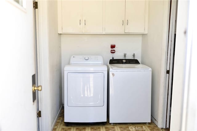 laundry room with independent washer and dryer and cabinets