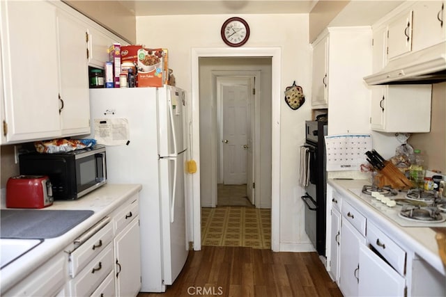 kitchen featuring dark hardwood / wood-style floors, white appliances, and white cabinetry