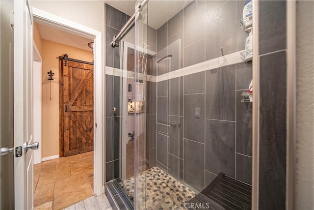 bathroom with a shower with door