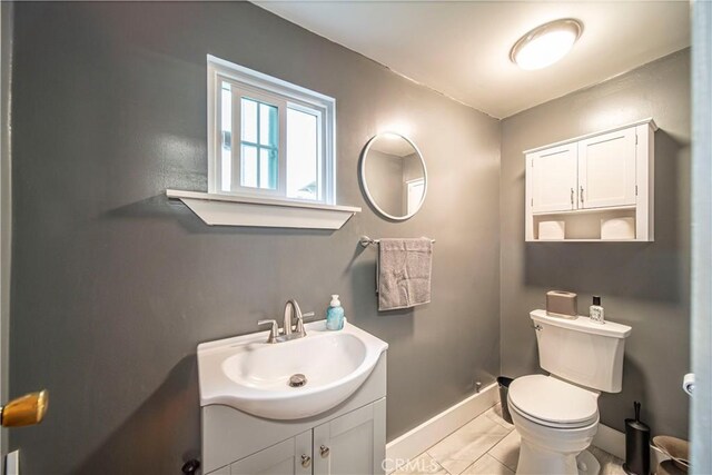 bathroom featuring tile patterned floors, vanity, and toilet