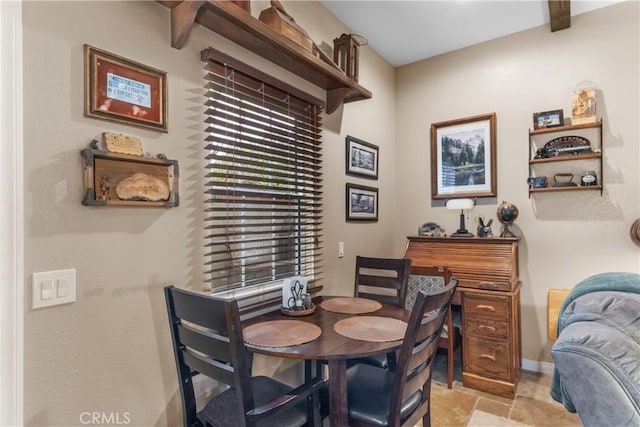 dining room with beamed ceiling