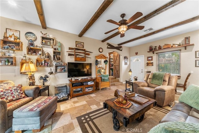 living room featuring beamed ceiling and ceiling fan