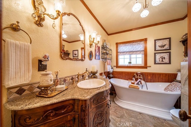 bathroom with a tub, vanity, and ornamental molding