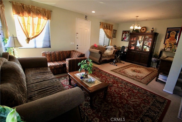 living room with carpet floors and an inviting chandelier