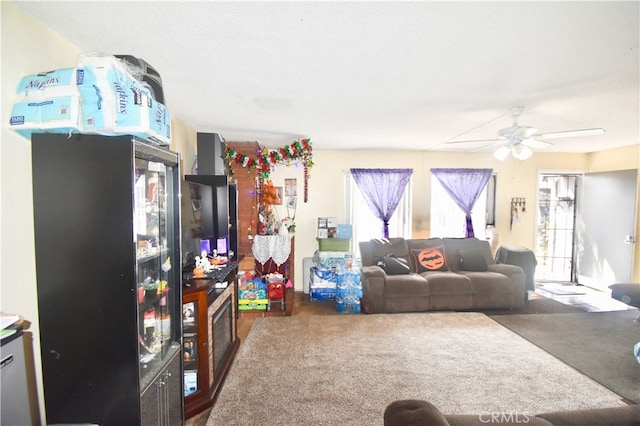 living room featuring ceiling fan and carpet floors