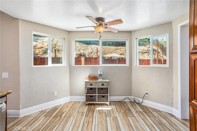 interior space featuring ceiling fan and a healthy amount of sunlight