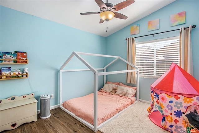 bedroom with hardwood / wood-style floors, ceiling fan, and vaulted ceiling