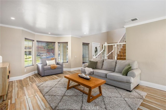 living room featuring light hardwood / wood-style floors and ornamental molding