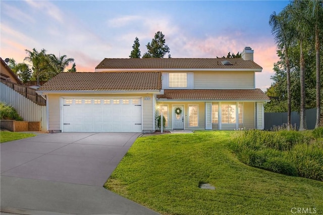 view of front of home with a lawn and a garage