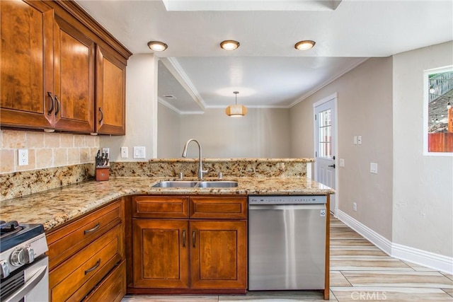 kitchen with kitchen peninsula, appliances with stainless steel finishes, plenty of natural light, and sink