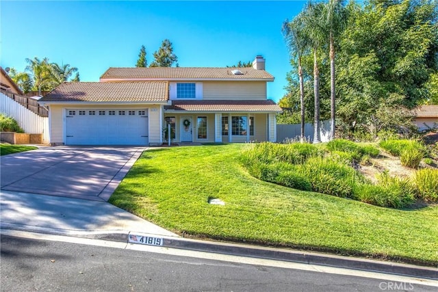 view of front facade featuring a garage and a front lawn