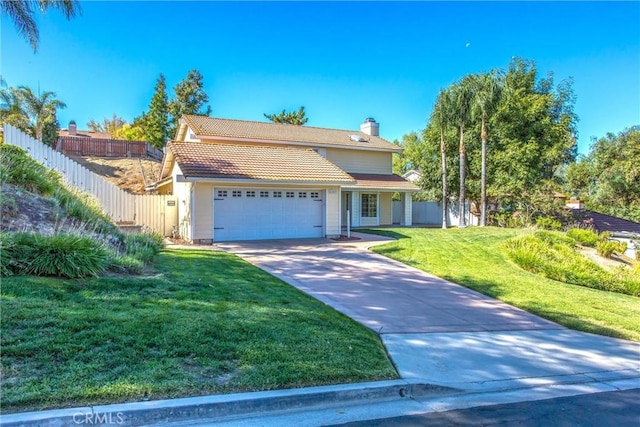 view of front of property with a garage and a front lawn