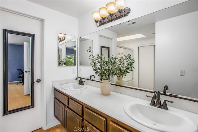 bathroom with ceiling fan and vanity