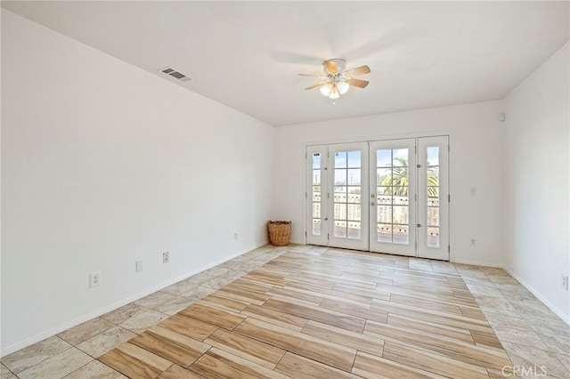 spare room featuring french doors, light hardwood / wood-style floors, and ceiling fan