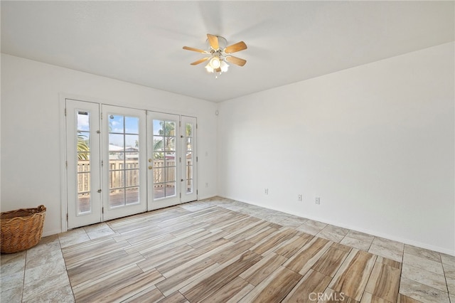 empty room featuring french doors, ceiling fan, and light hardwood / wood-style flooring