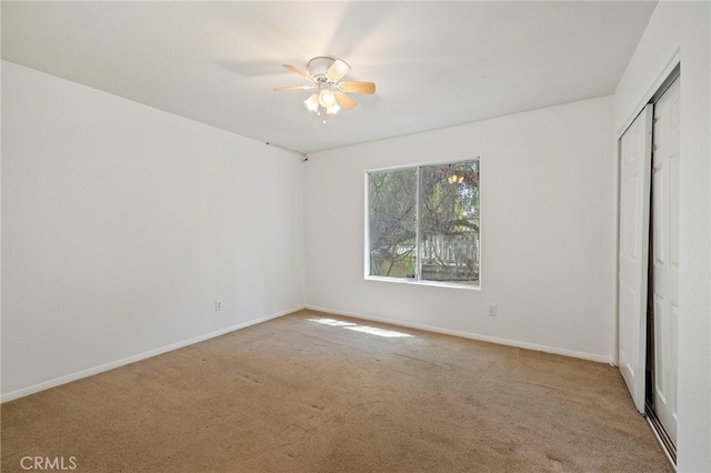 unfurnished bedroom with a closet, ceiling fan, and light colored carpet