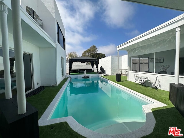 view of swimming pool with a gazebo, a patio area, and a lawn