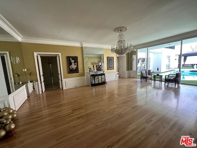 interior space featuring crown molding, a notable chandelier, and dark hardwood / wood-style flooring