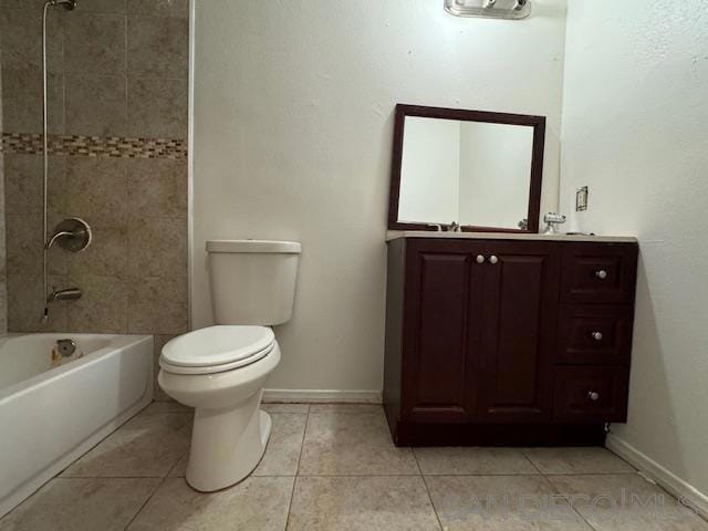 bathroom with tile patterned floors, tiled shower / bath combo, and toilet