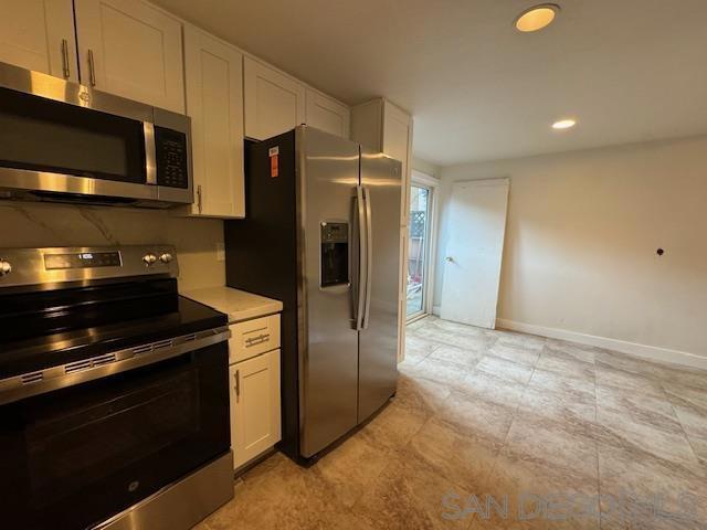 kitchen with stainless steel appliances and white cabinetry