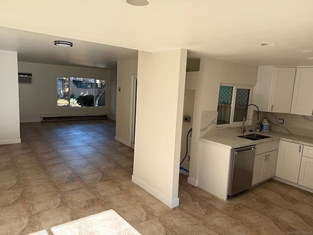 kitchen with dishwasher, sink, a baseboard heating unit, a wall mounted AC, and white cabinets