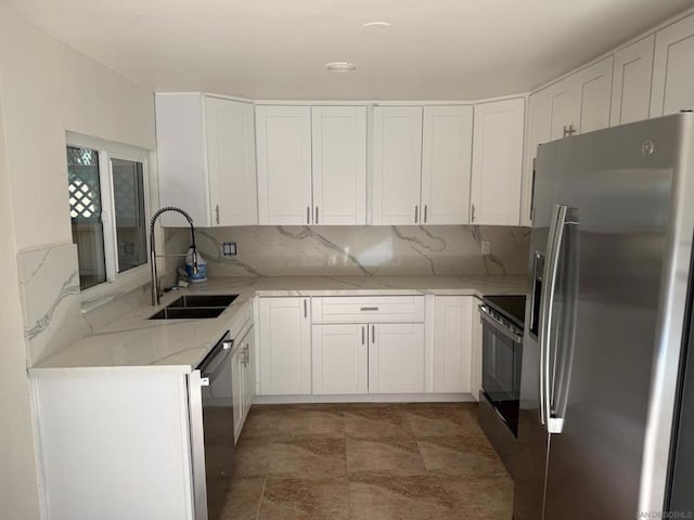 kitchen with decorative backsplash, light stone countertops, sink, and appliances with stainless steel finishes