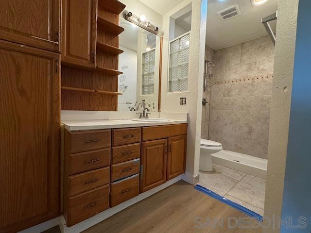 kitchen with light stone countertops, white cabinetry, sink, and appliances with stainless steel finishes