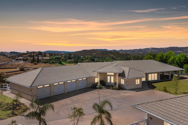 view of front facade with a mountain view and a garage