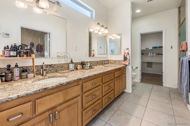 bathroom with tile patterned floors, vanity, and toilet