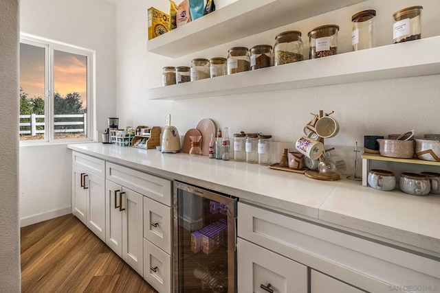 bar featuring white cabinets, light hardwood / wood-style flooring, and wine cooler