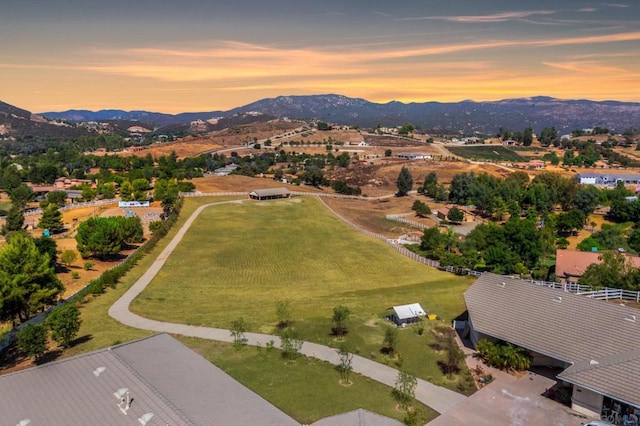 aerial view at dusk featuring a mountain view