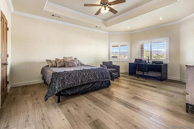 bedroom with a raised ceiling, ceiling fan, light hardwood / wood-style floors, and ornamental molding