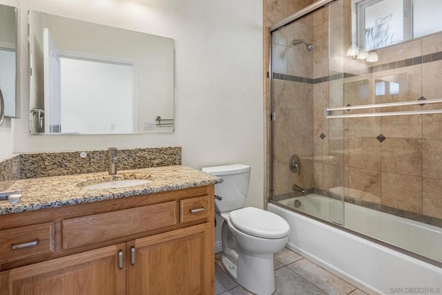 full bathroom featuring tile patterned flooring, vanity, toilet, and enclosed tub / shower combo