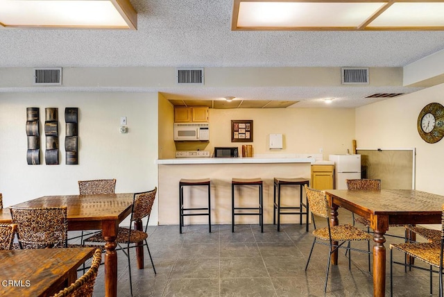 dining room with a textured ceiling