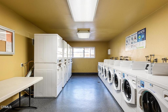 washroom with stacked washer and dryer and washing machine and clothes dryer