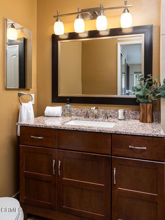 bathroom with vanity and toilet