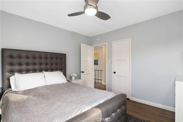 bedroom with ceiling fan and dark hardwood / wood-style floors