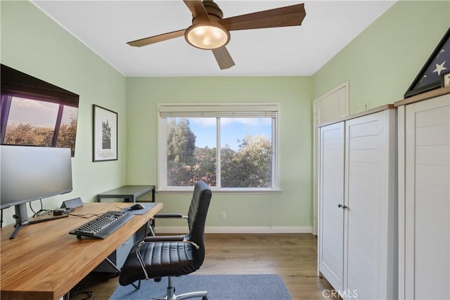 office featuring wood finished floors, baseboards, and ceiling fan