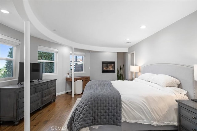 bedroom with recessed lighting, baseboards, and wood finished floors