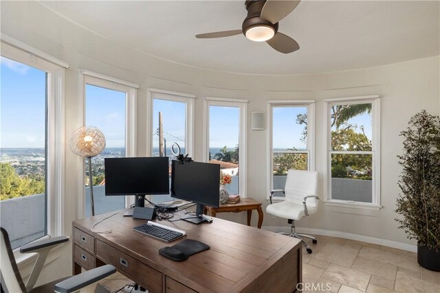 office area with plenty of natural light and ceiling fan