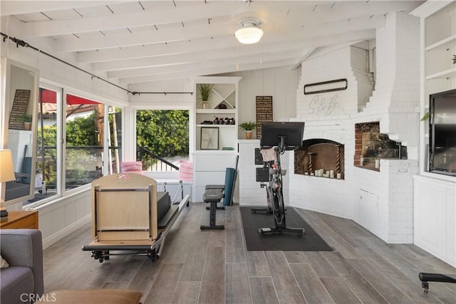 workout area featuring hardwood / wood-style flooring and lofted ceiling