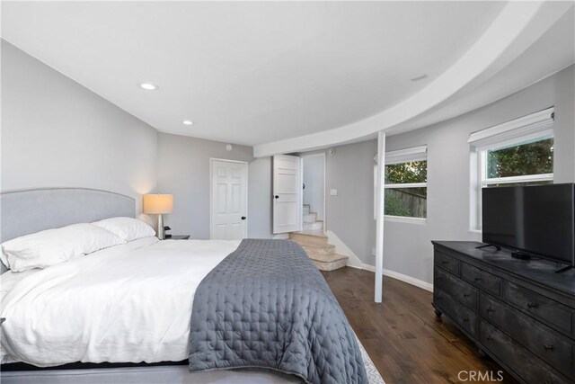 bedroom with dark hardwood / wood-style flooring