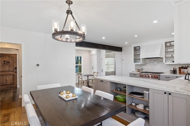 dining room with light wood finished floors, a chandelier, and recessed lighting
