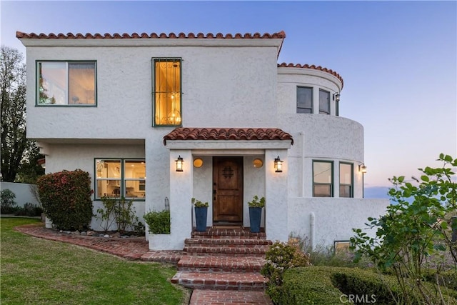 6401 Corsini Pl, Rancho Palos Verdes, CA 90275 - mediterranean / spanish-style home with a front lawn, a tiled roof, stucco siding, and fence